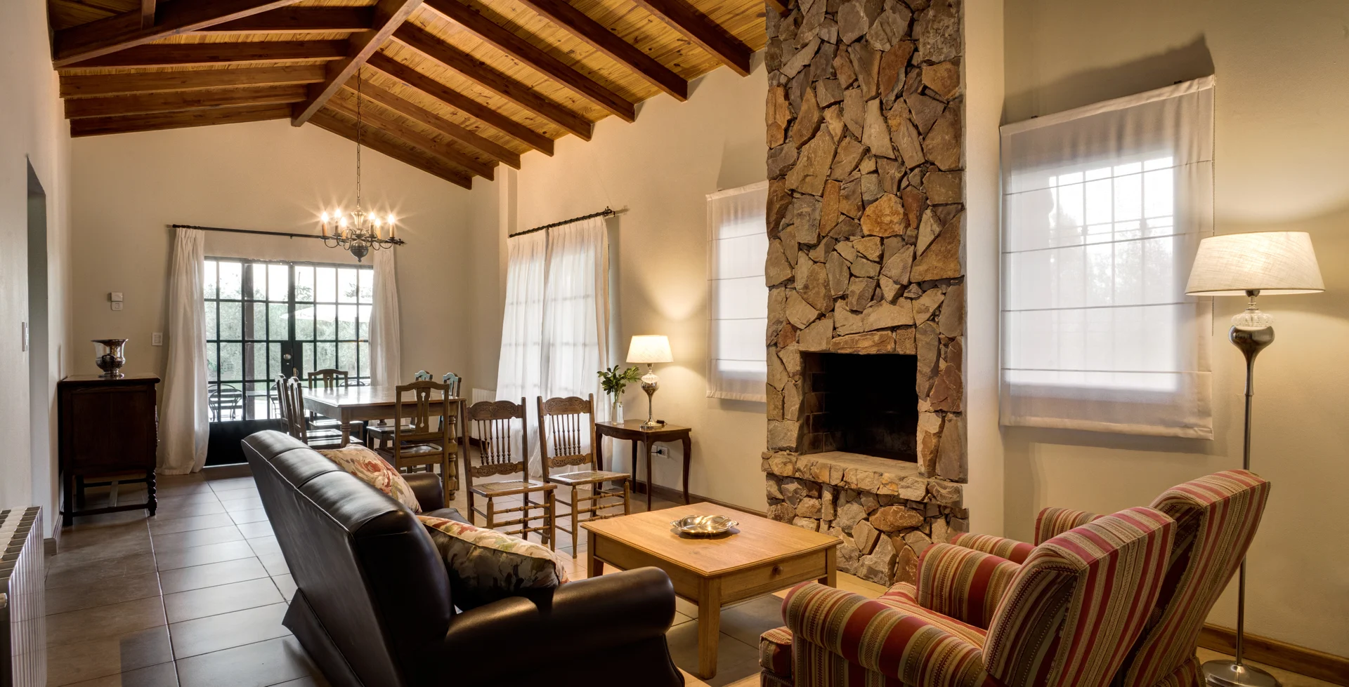 Cozy living and dining room with fireplace at private Villa Verde Oliva in Maipú Mendoza